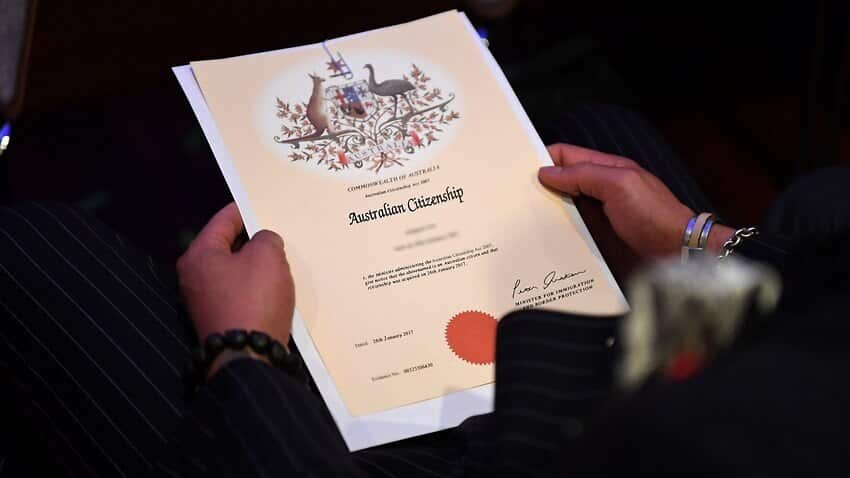 An Australian citizenship recipient holds his certificate during a citizenship ceremony on Australia Day in Brisbane