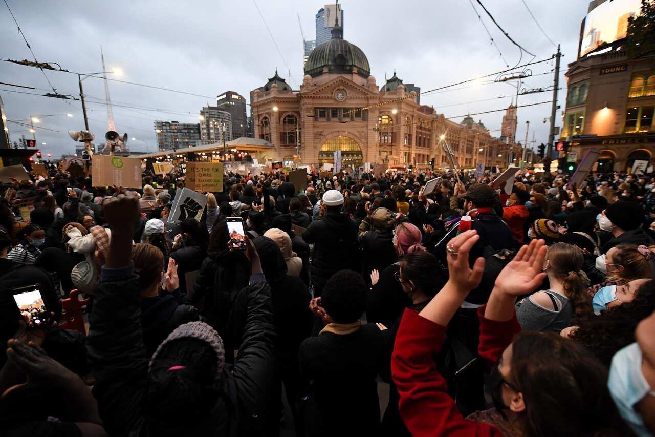 Protesters are seen during a Black Lives Matter rally in Melbourne on 6 June.