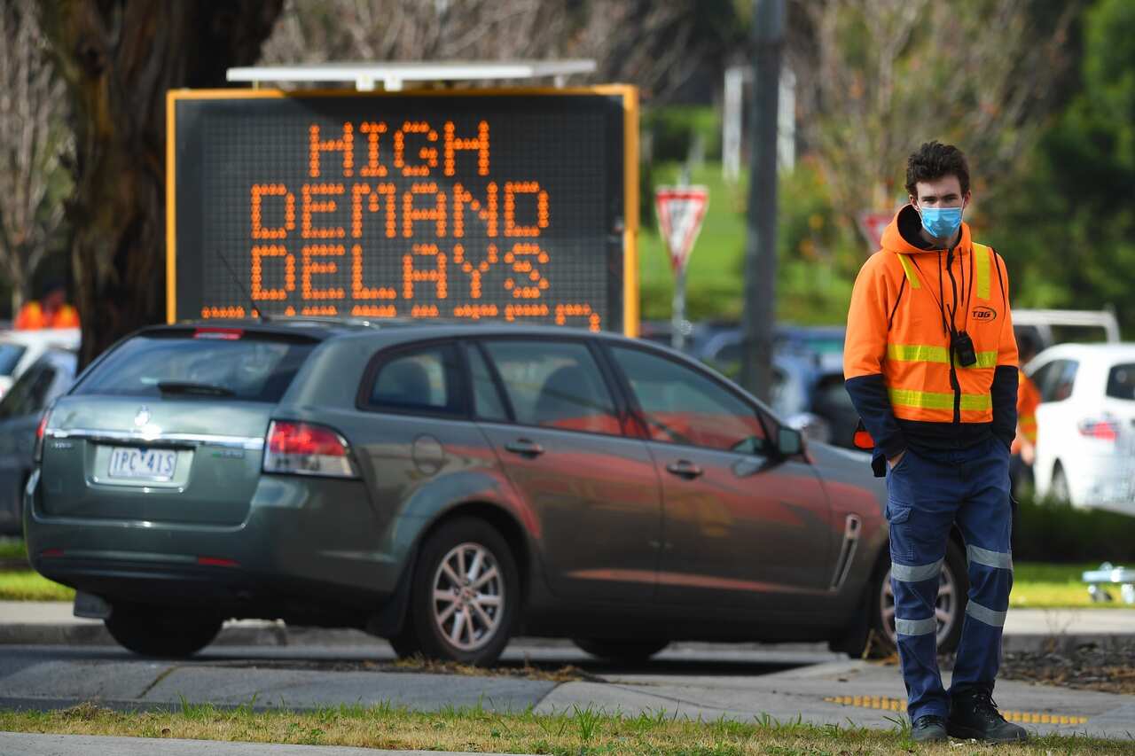 Traffic management is seen outside a COVID-19  testing facility at Northland shopping centre in Melbourne.