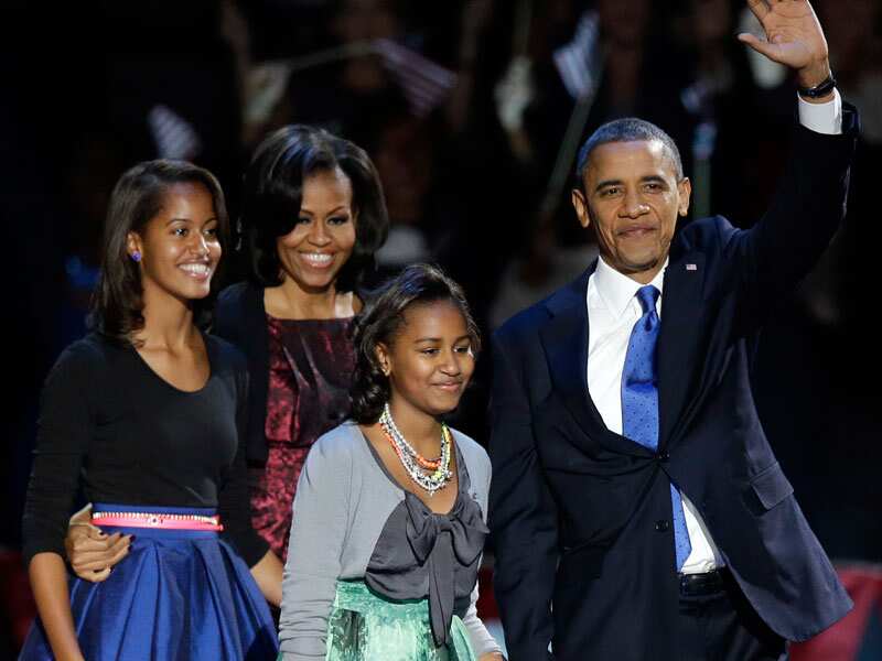 President Barack Obama with first lady Michelle Obama and daughters Malia and Sasha at his election night party in Chicago. President Obama defeated Republican challenger former Massachusetts Gov. Mitt Romney. (AAP)