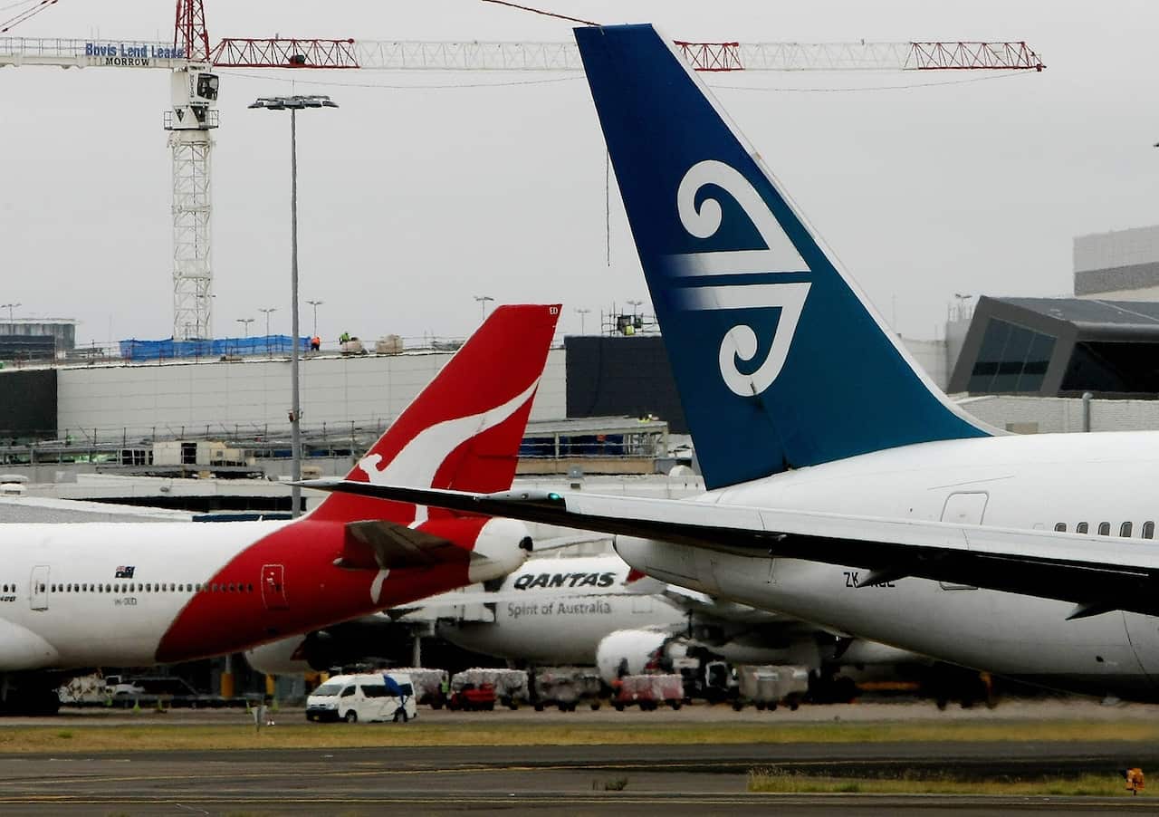 The tails of a Qantas plane and an Air New Zealand plane at Sydney Airport.