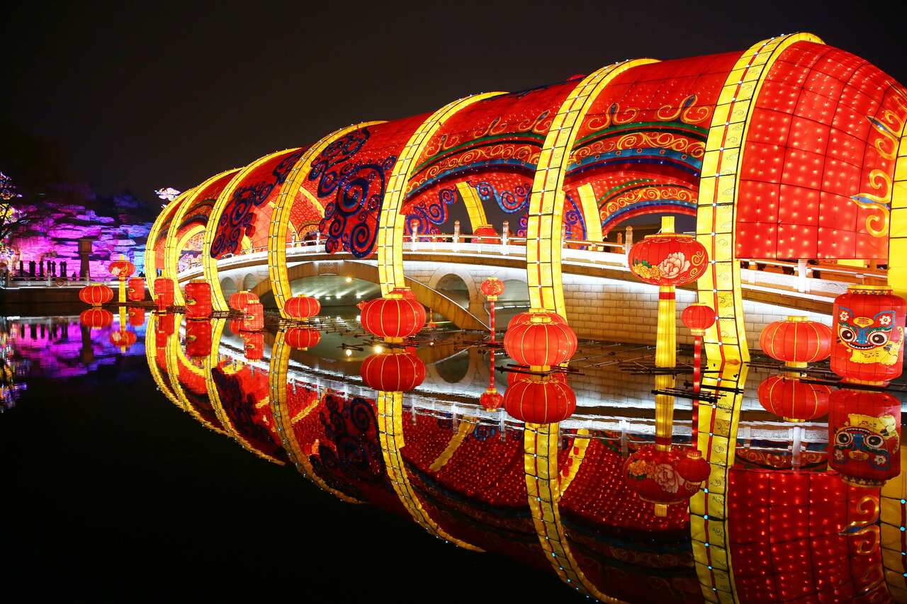 LColored lanterns are illuminated on the water during a lantern show.