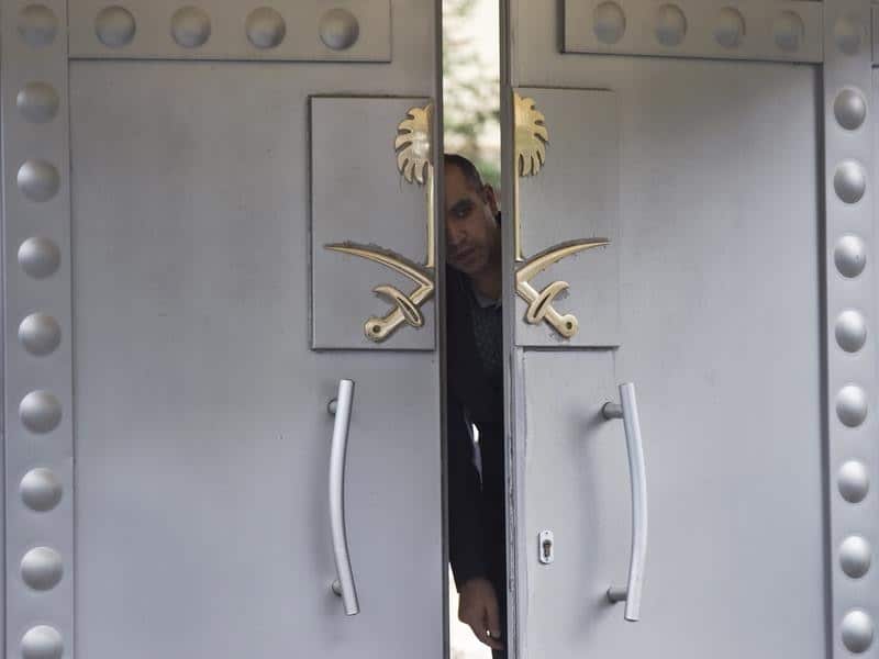 A security personnel peeps from the doors of the Saudi Arabia consul
