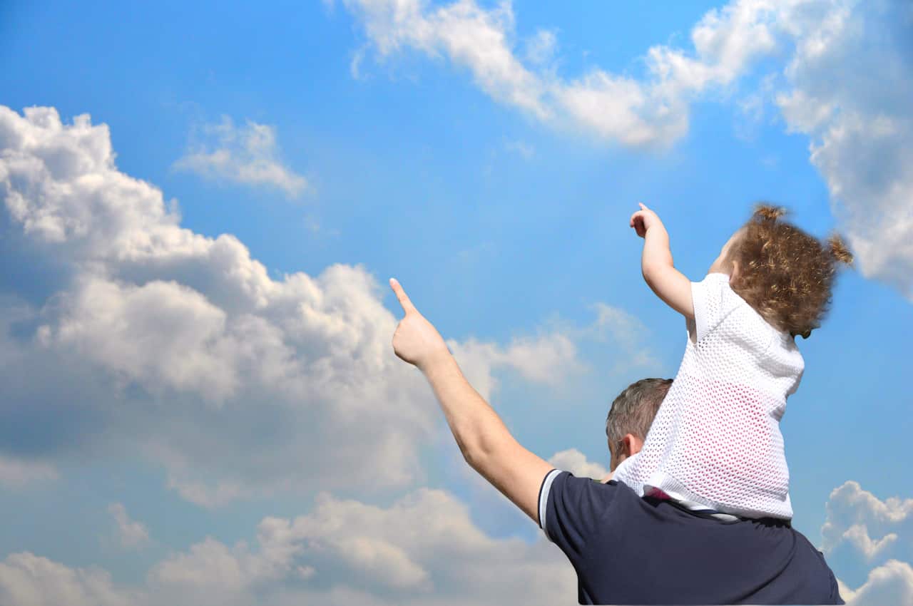 Father daughter look at the sky