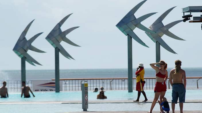 Stock photograph shows tourists sunbaking at the "Lagoon" situated on the esplanade in Cairns, Far North Queensland.