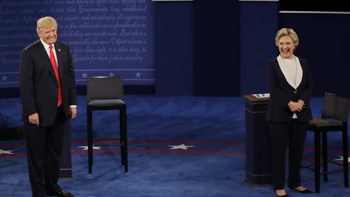 Republican presidential nominee Donald Trump and Democratic presidential nominee Hillary Clinton react to a question during the second presidential debate at Washington University in St. Louis, Sunday, Oct. 9, 2016. (AP Photo/Patrick Semansky)