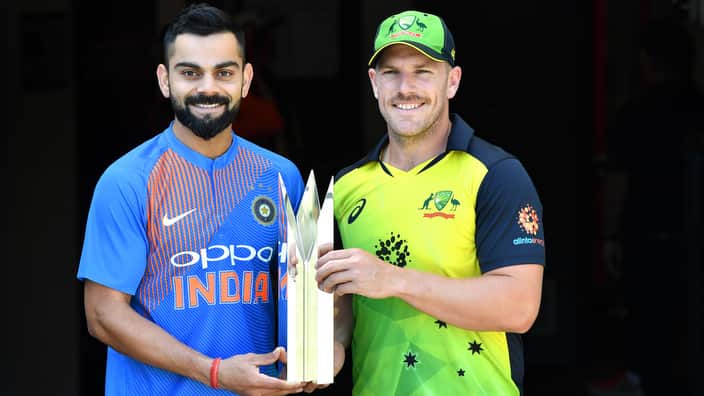 Virat Kohli (left) of India and Aaron Finch (right) of Australia are seen posing for a photo with the series trophy at the Gabba in Brisbane.
