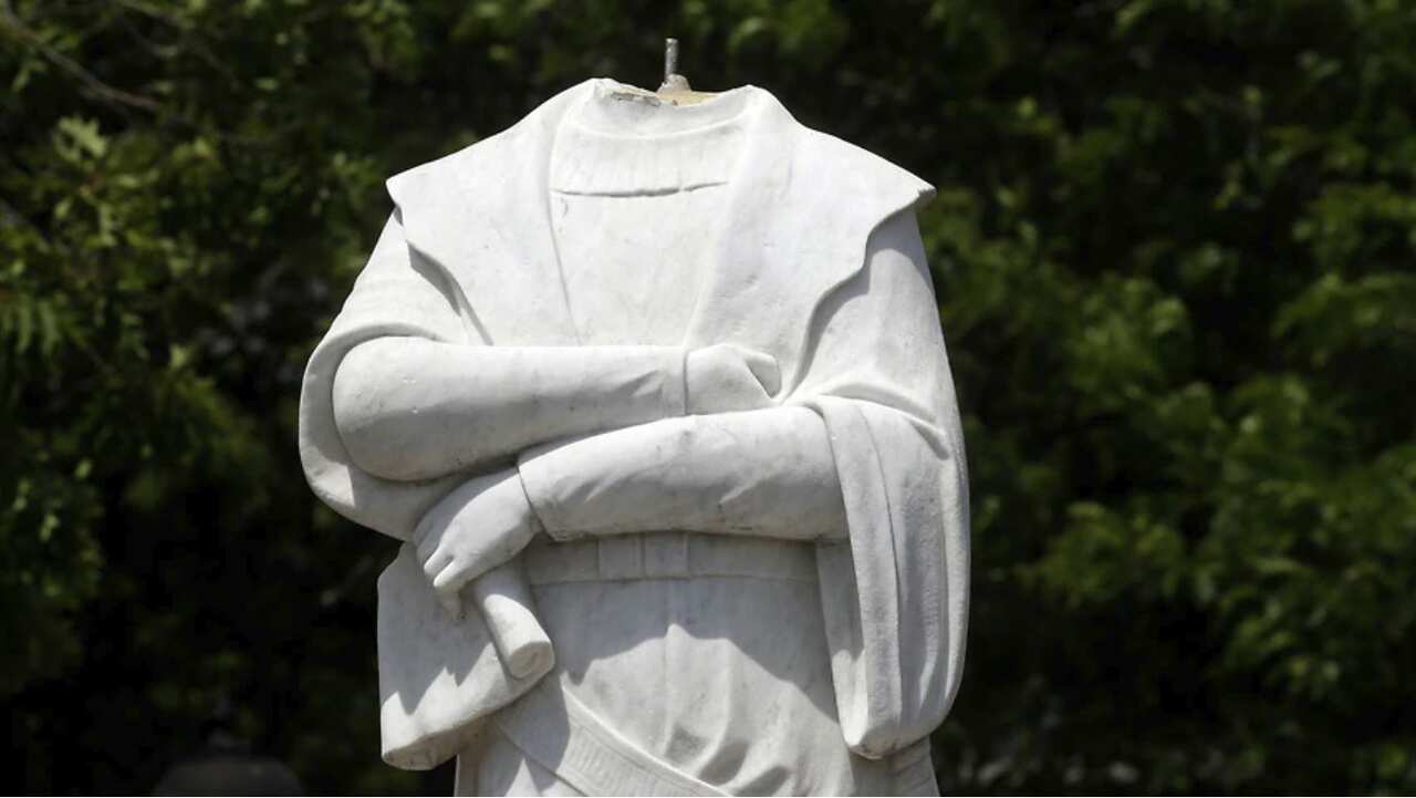 A beheaded Christopher Columbus statue stands in a waterfront park in Boston, USA
