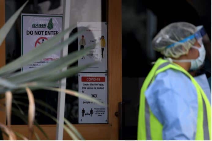 COVID-19 and social distancing signage is seen at the Crossroads Hotel in Sydney, Saturday, July 11, 2020