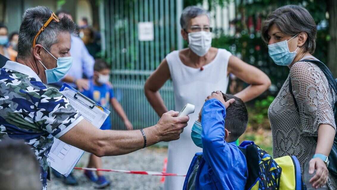 Students have their temperature checked as they arrive at Baricco primary school in Turin, Italy. 