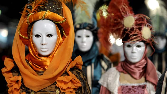 Women with masks participate in a carnival procession in Strumica, Macedonia,  Saturday, Feb. 25, 2012. More than 2,500 costumed revelers performed Saturday, the main night of the carnival, through downtown Strumica.  (AP Photo/Boris Grdanoski)