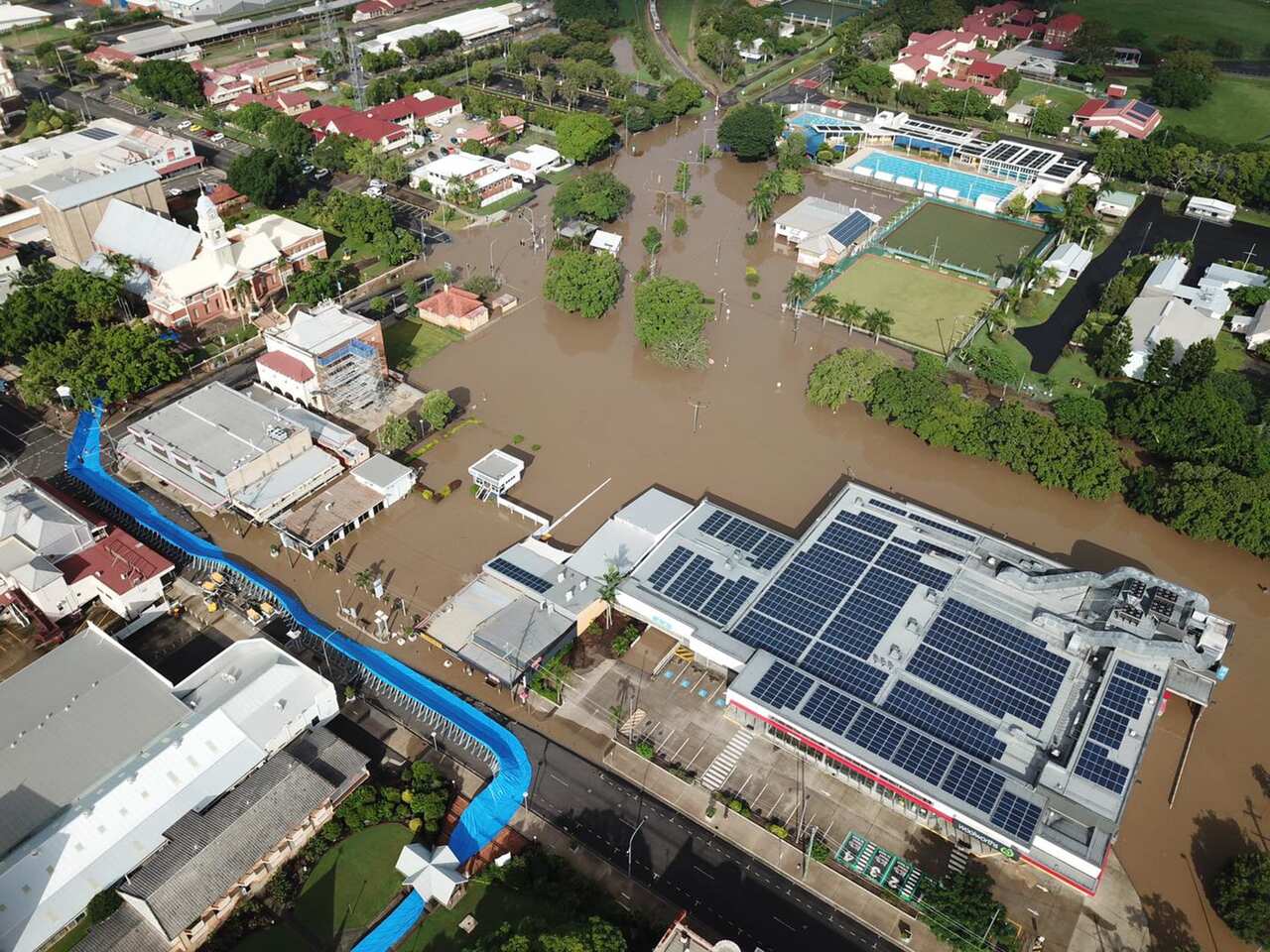 A supplied image shows an aerial view of floodwaters impacting the CBD of Maryborough, north of Brisbane. 