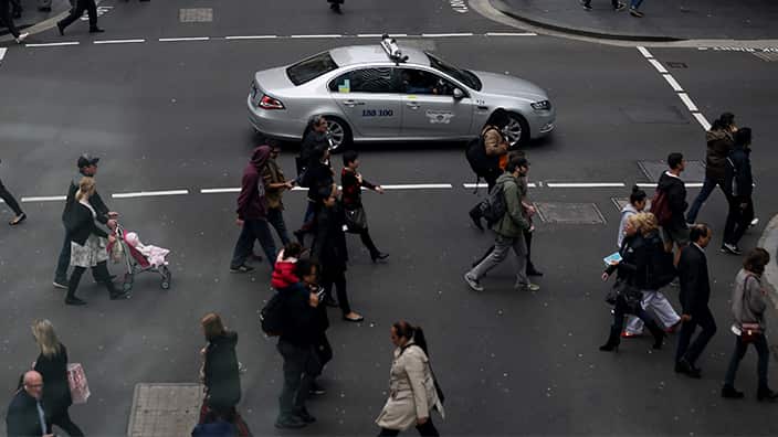 Pedestrians crossing the street in Sydney