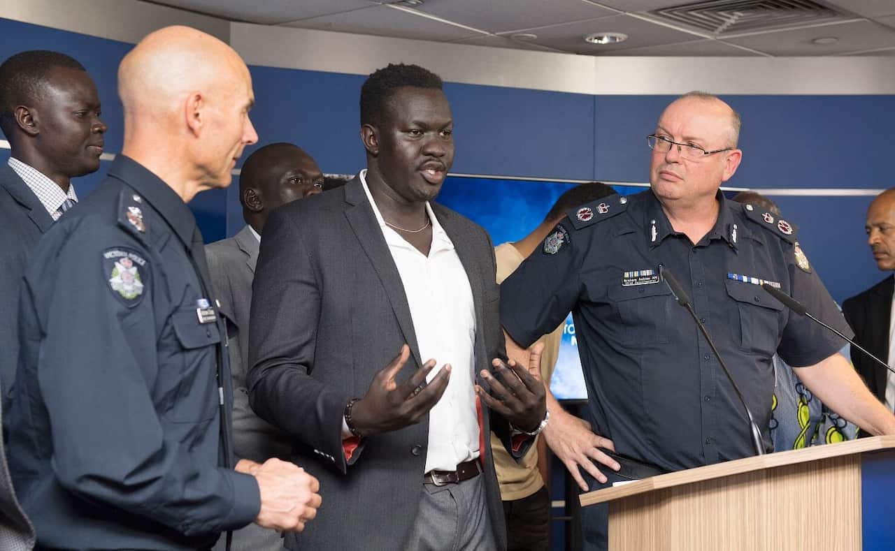 Victorian Deputy Commissioner Andrew Crisp (left) and Chief Police Commissioner Graham Ashton listen as African community leader John Kuot 