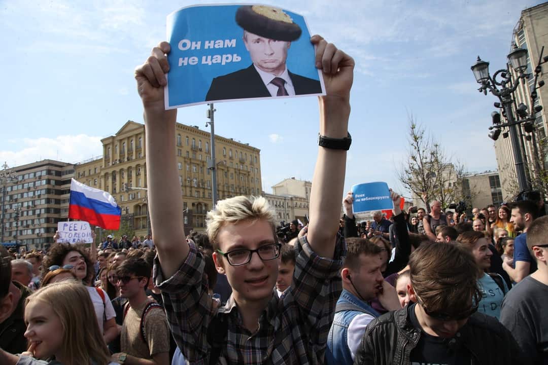 A man holds a poster during the demonstration against President Vladimir Putin at Pushkin Square in Moscow, Russia.