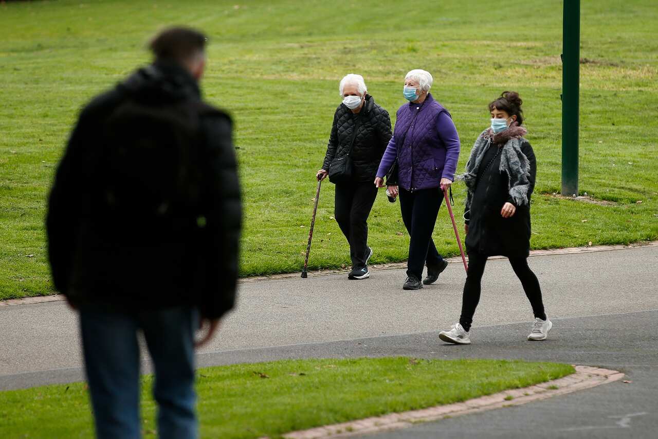 People are seen wearing masks in the Fitzroy Gardens in Melbourne, Wednesday, July 29, 2020. There are now 4775 active COVID-19 cases across Victoria and 769 of those are linked to aged care homes. (AAP Image/Daniel Pockett) NO ARCHIVING