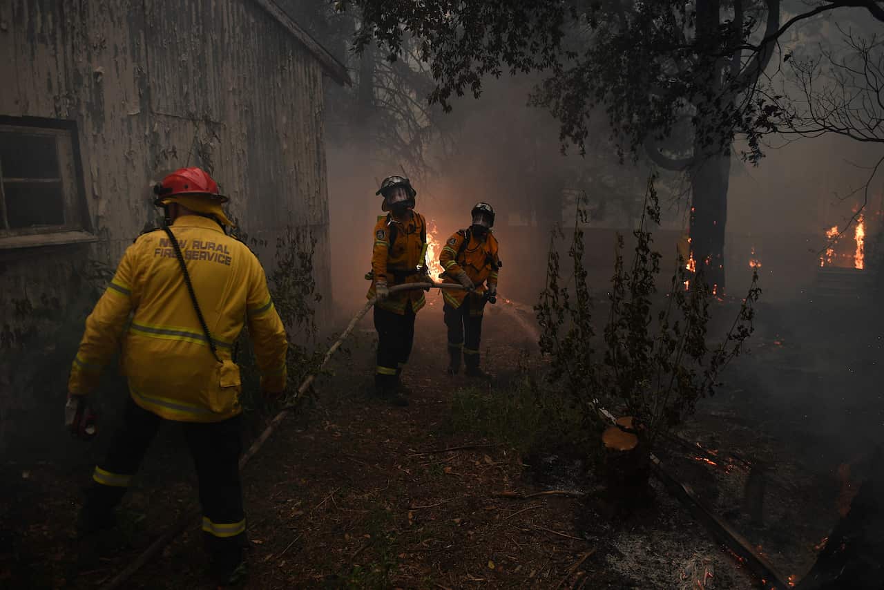 NSW Rural Fire Service crews fight the Gospers Mountain Fire as it impacts property at Bilpin.
