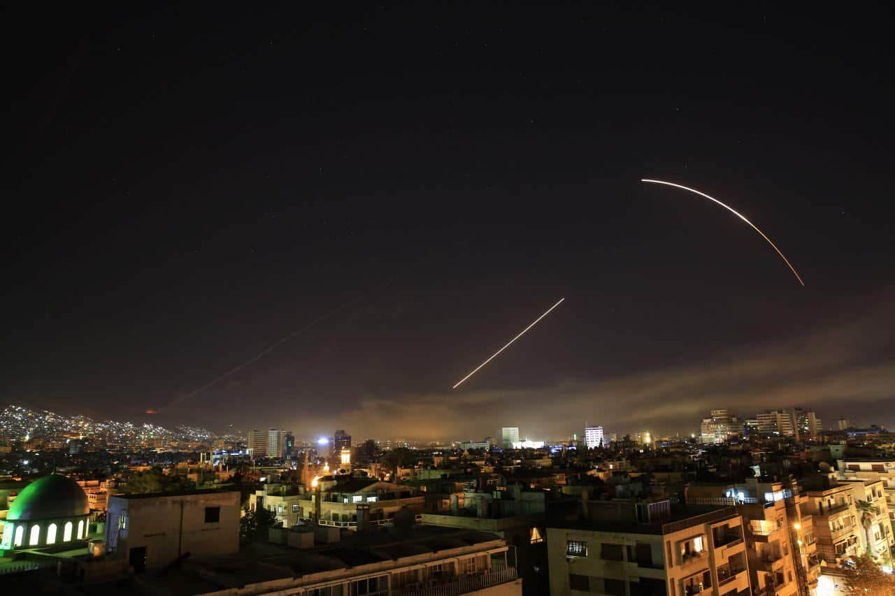 Missiles streak across the Damascus skyline as the U.S. launches an attack on Syria targeting different parts of the capital, early Saturday, April 14, 2018.