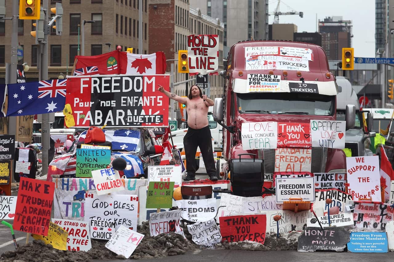 A protester participates in a blockade of downtown streets near the parliament building as demonstrations continue.
