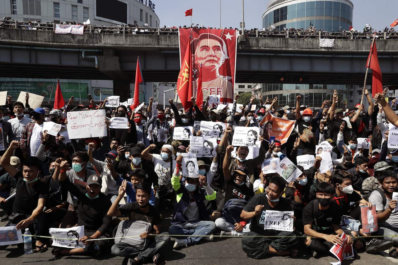 Demonstrators hold banners and shout slogans during a protest against the military coup, in Yangon, Myanmar.