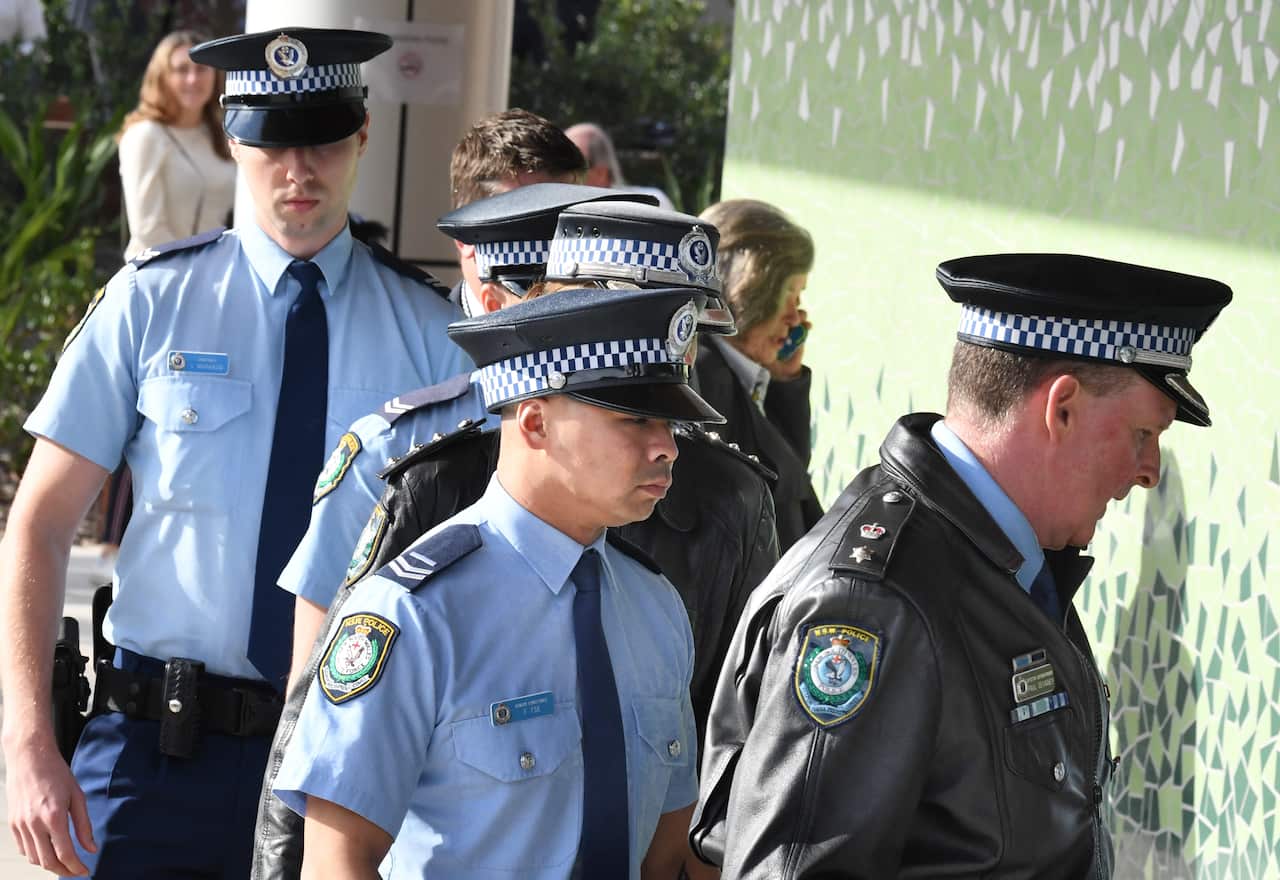 Senior Constable Frederick Tse (centre) arrives at the Lidcombe Coroners Court with fellow NSW police officers in Sydney.
