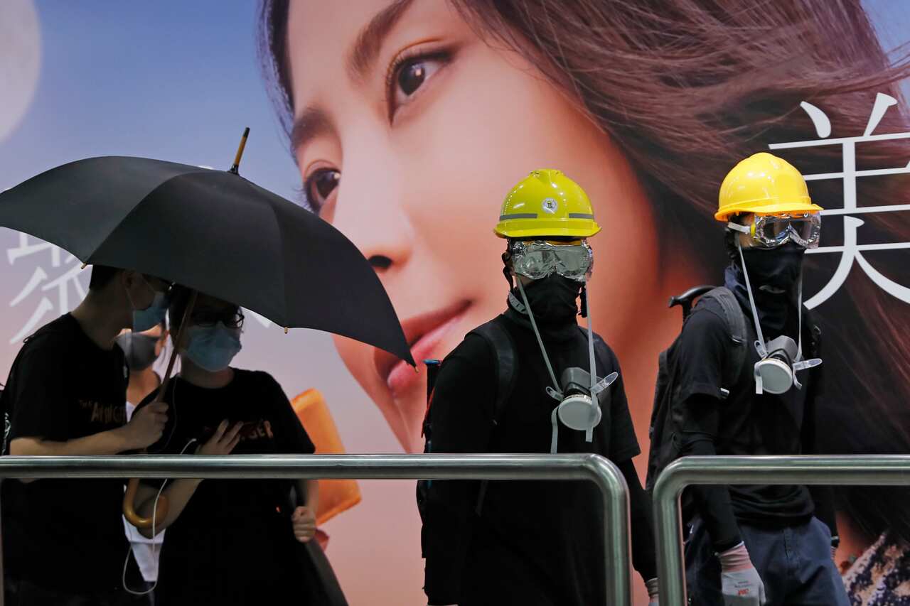 Demonstrators in Hong Kong move to a luxury shopping district Sunday evening after riot police used tear gas to clear out an area they were previously occupying