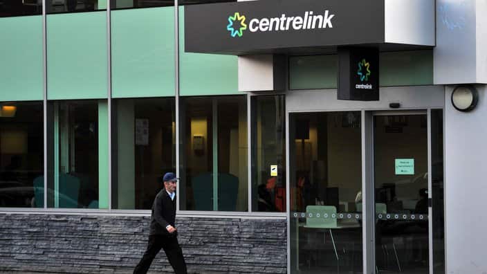 A man walks past a Centrelink branch in Melbourne.