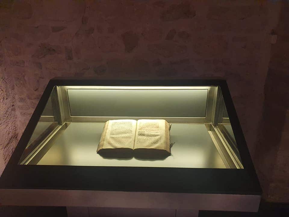The first book printed in Belgrade, 1552. a leaf, the book and the exhibition poster