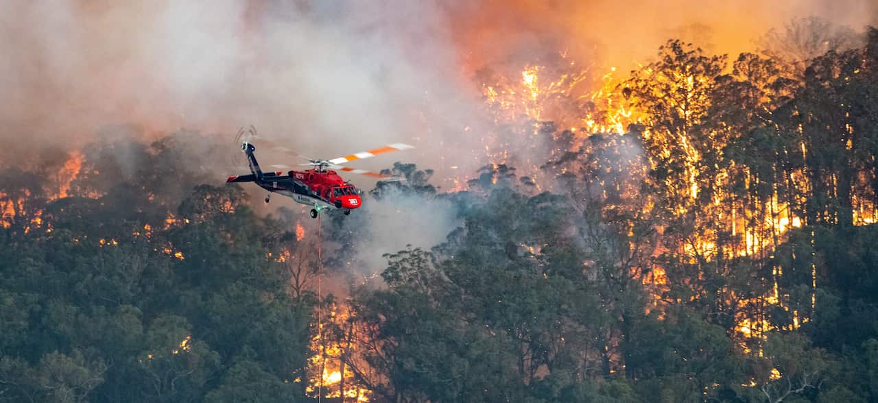 A firefighting helicopter battles a bushfire near Bairnsdale in Victoria's East Gippsland region.