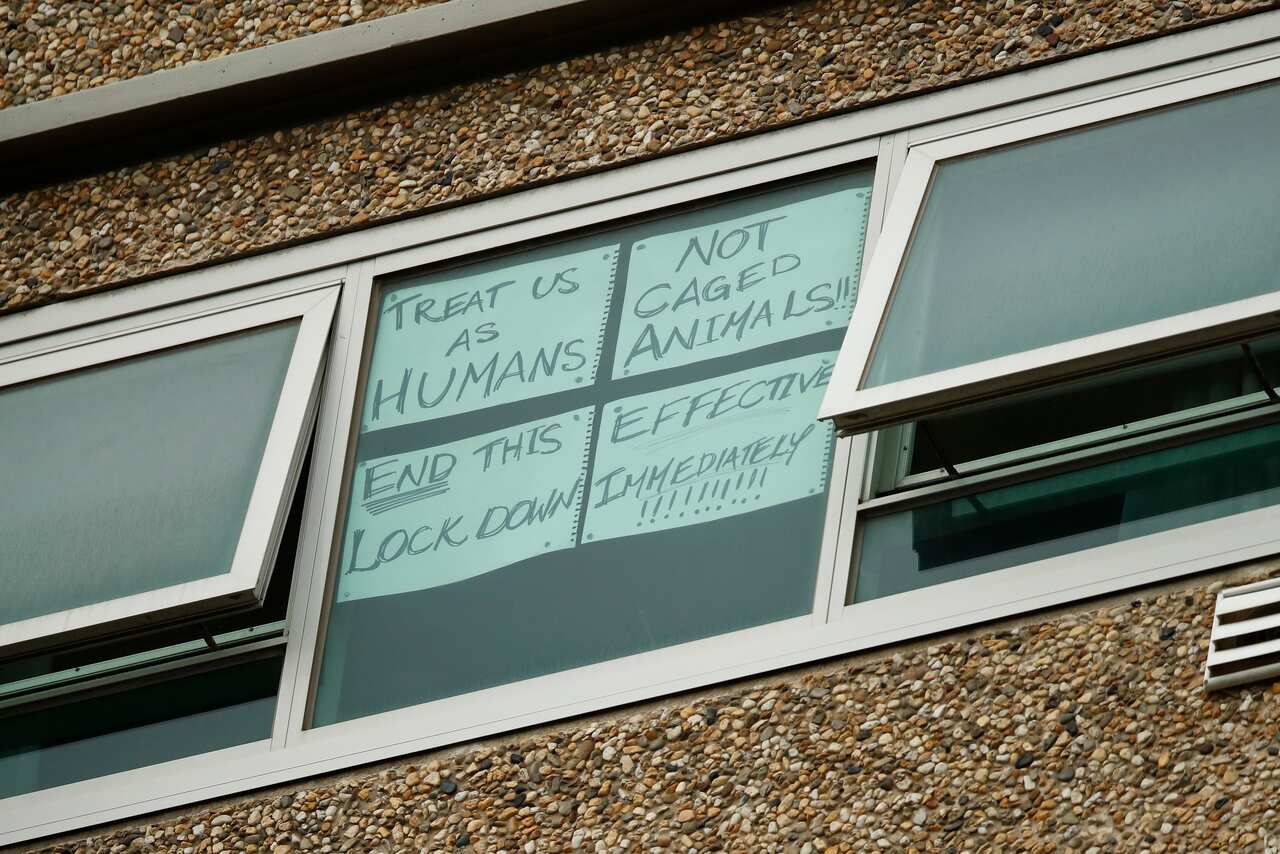 A sign is seen on a window at one of the public housing towers on Racecourse Road in Flemington, Melbourne. 