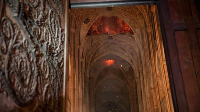 Photos Inside Notre Dame Show Charred Alter With A Hanging Cross Intact