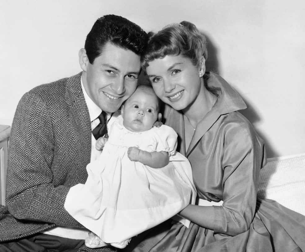 In this Jan. 2, 1957 file photo, Eddie Fisher and Debbie Reynolds hold their baby daughter, Carrie Frances Fisher (AAP)