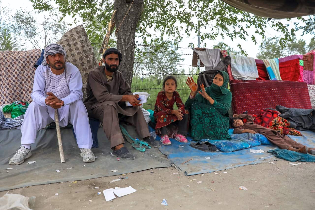 Families who fled fighting in Afghanistan's northern provinces shelter in a public park in Kabul, Afghanistan on 14 August 2021.