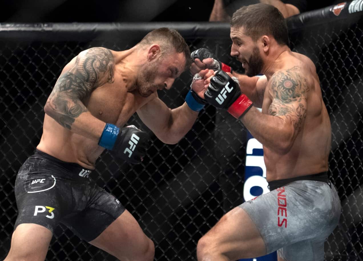 Alex Volkanovski, left, fights Chad Mendes during the first round of a featherweight mixed martial arts bout at UFC 232, Saturday, Dec. 29, 2018