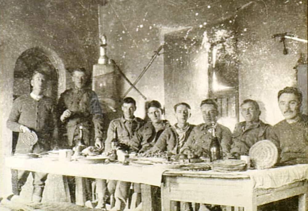 Note the round Indian bread Chapattis being held up for the camera by two of the soldiers. 