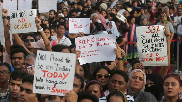 People  holds play card against recent incidents of rape in the country, in Mumbai, India, Sunday, April 15, 2018.