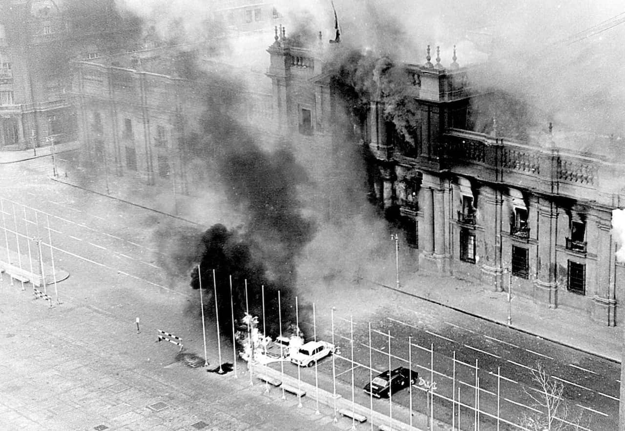 -Smoke pours from the Chilean presidential palace, La Moneda, in this Sept. 11, 1973 file photo after being hit by rockets fired by the air force Hawker Hunter jet fighters