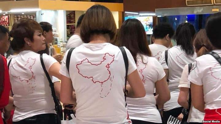 A group of Chinese tourists to Nha Trang wearing T shirt with map of China including Cow's Tongue