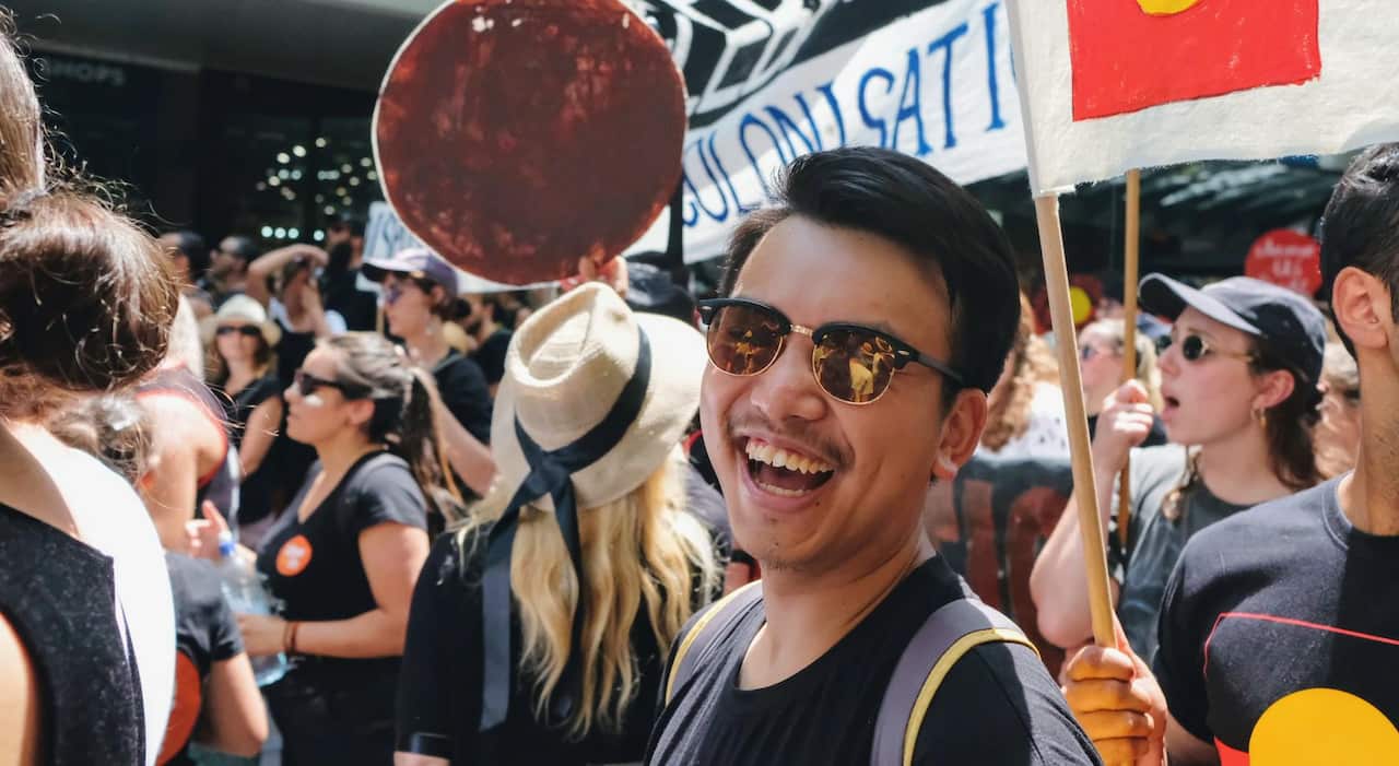 Young man smiling at a protest march