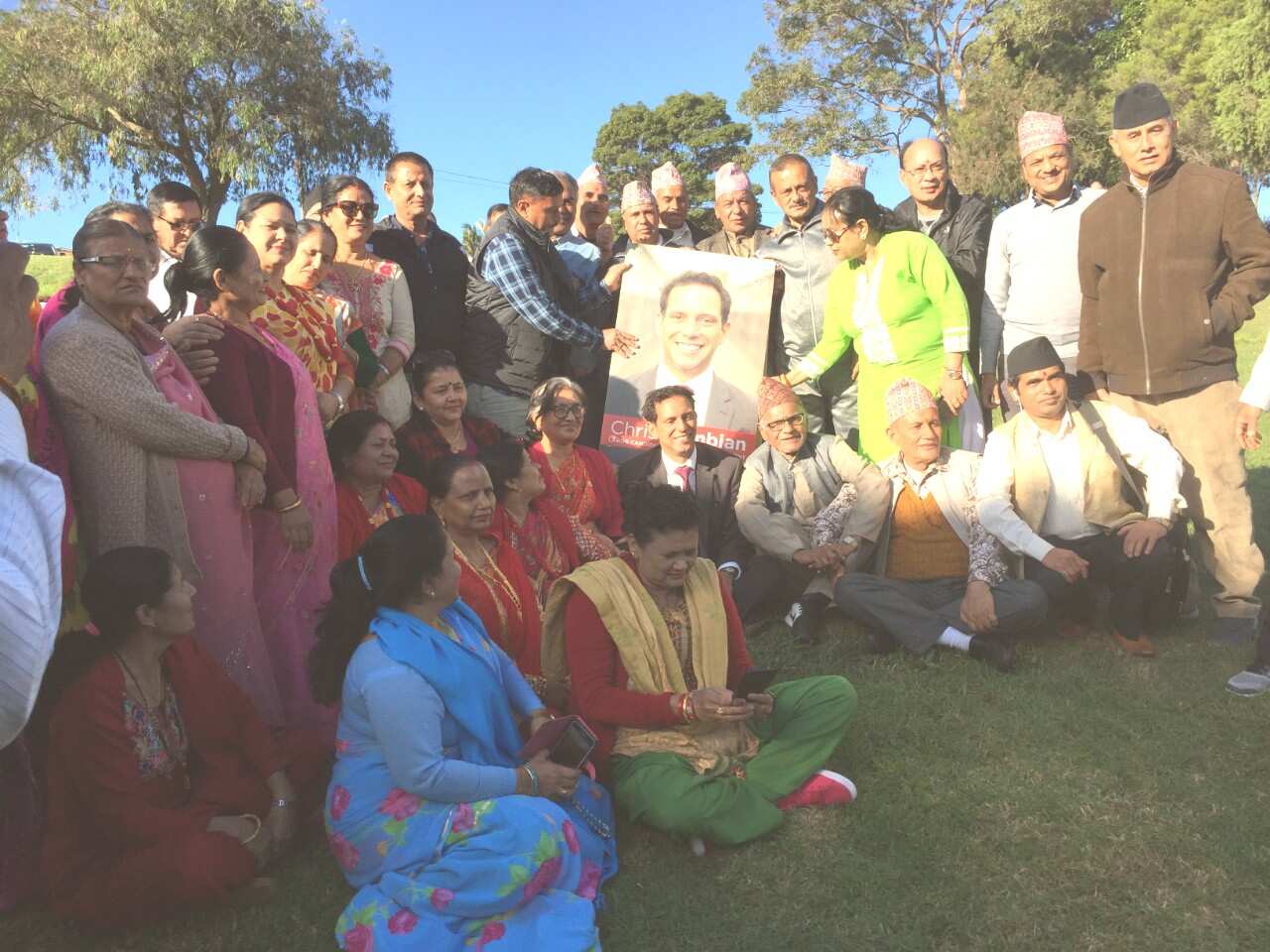 Chris Gambian Labor candidate for Banks posing for photo with Nepali community members