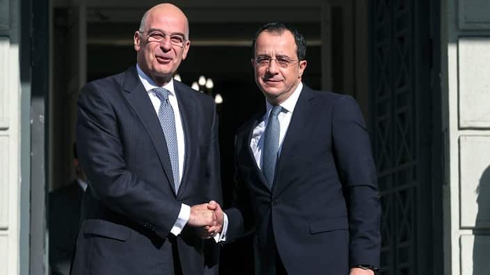 Greek Foreign Minister Nikos Dendias, left, shakes hands with his Cypriot counterpart Nikos Christodoulides before their meeting in Athens, on Monday, Jan. 13, 2020. (AP Photo/Petros Giannakouris)