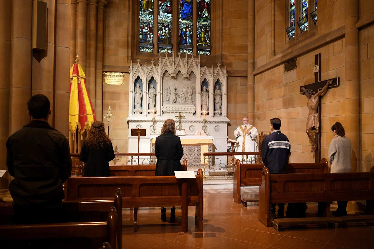 Dean of the Cathedral, Father Don Richardson gives mass at St Mary's Cathedral in Sydney, Friday, May 15, 2020.
