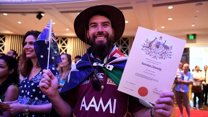 Mark Alcorn of Ireland celebrates receiving his Australian citizenship at a citizenship ceremony on Australia Day in Brisbane, Thursday, Jan. 26, 2017. (AAP Image/Dan Peled) NO ARCHIVING