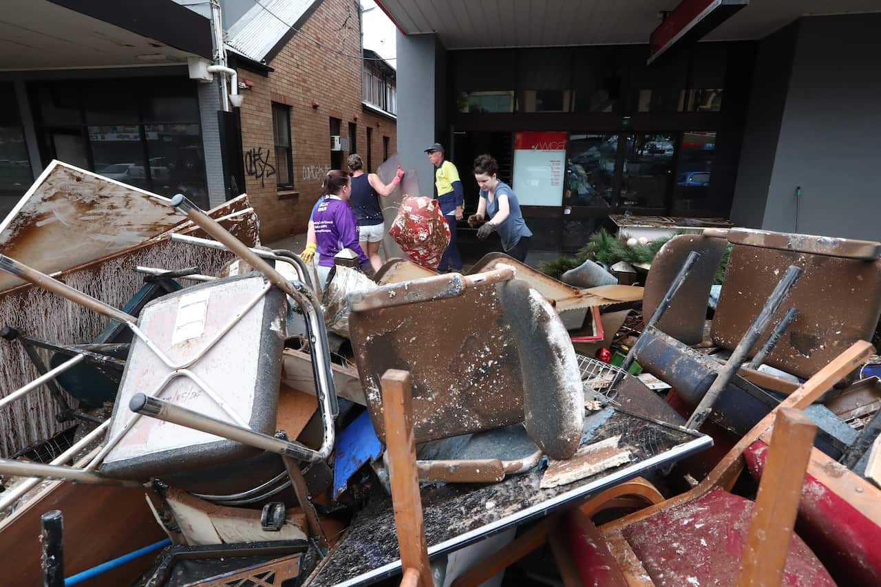 Lismore locals help with the clean up in the Central Business District in Lismore, Northern NSW, Thursday, March 3, 2022. The clean up is underway in towns across northern NSW. (AAP Image/Jason O'Brien) NO ARCHIVING