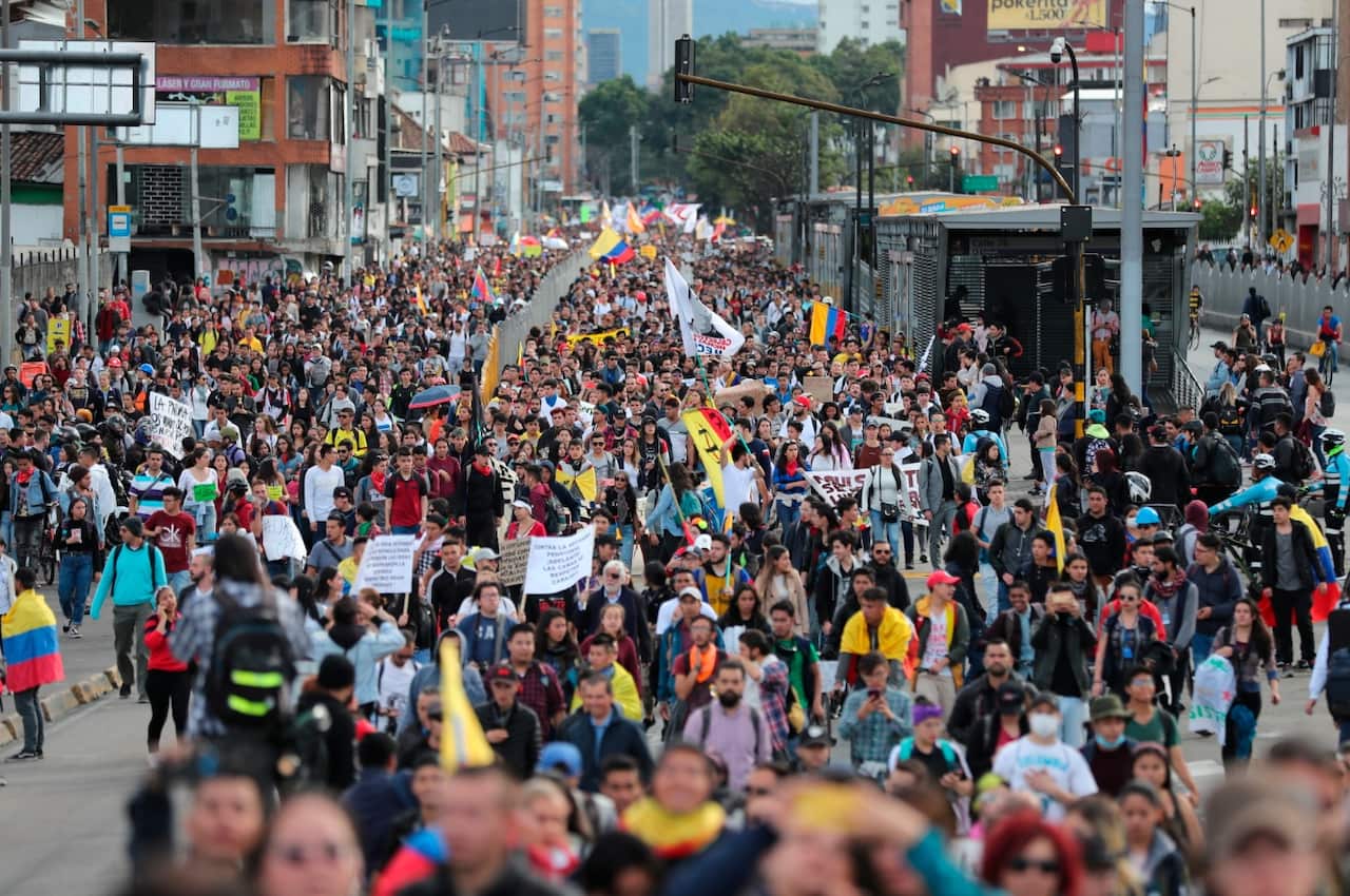 Anti-government protesters march in Bogota, Colombia, Wednesday, Nov. 27, 2019. 