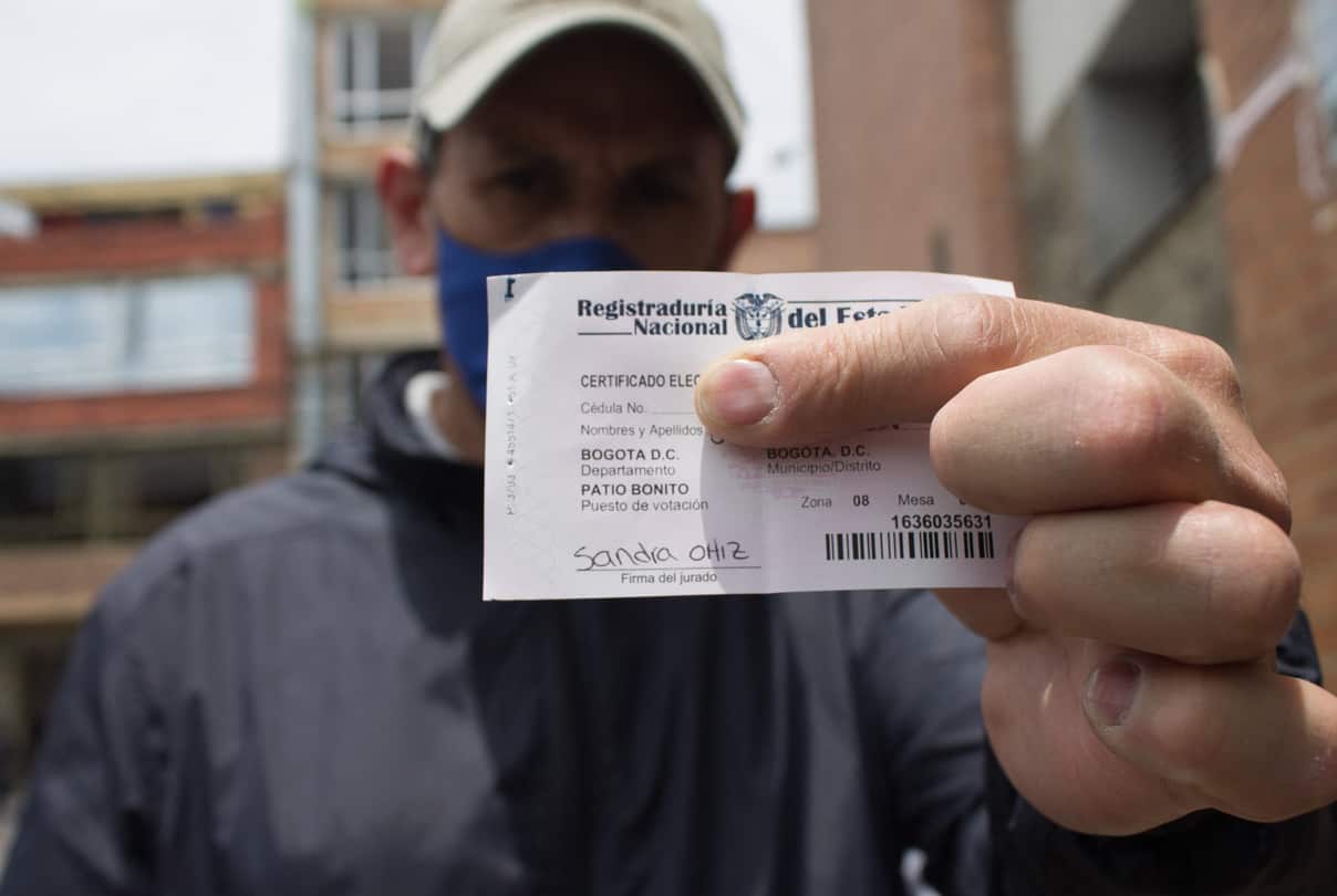A man shows his voting certificate during the 2022 Congressional elections in Colombia, on March 13, 2022, in Bogota, Colombia.