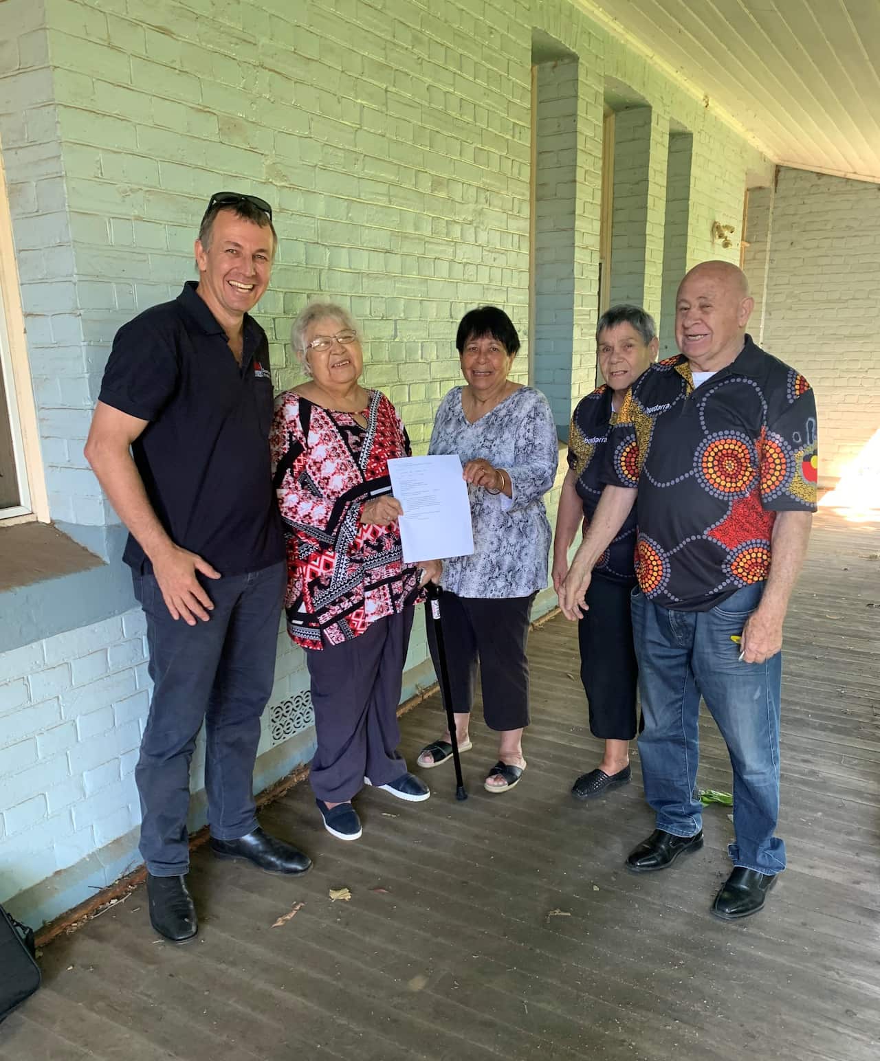 Crown Lands officer Shane Smith hands Certificate of Title to Coonabarabran LALC Board members Irene Nixon, Margaret Leslie, Beryl Dowd & Casey Dowd.