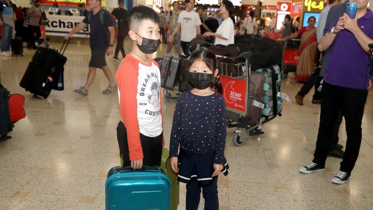 Children, wearing face masks at Sydney airport
