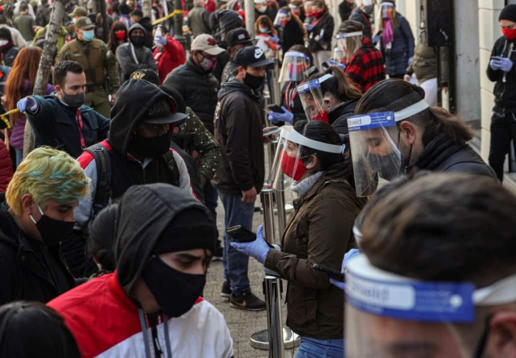 Government employees help people process their request for an early withdrawal of a percentage of their pension in Chile in July, 2020.