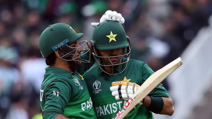 Pakistan's captain Sarfaraz Ahmed, left, embraces teammate Babar Azam